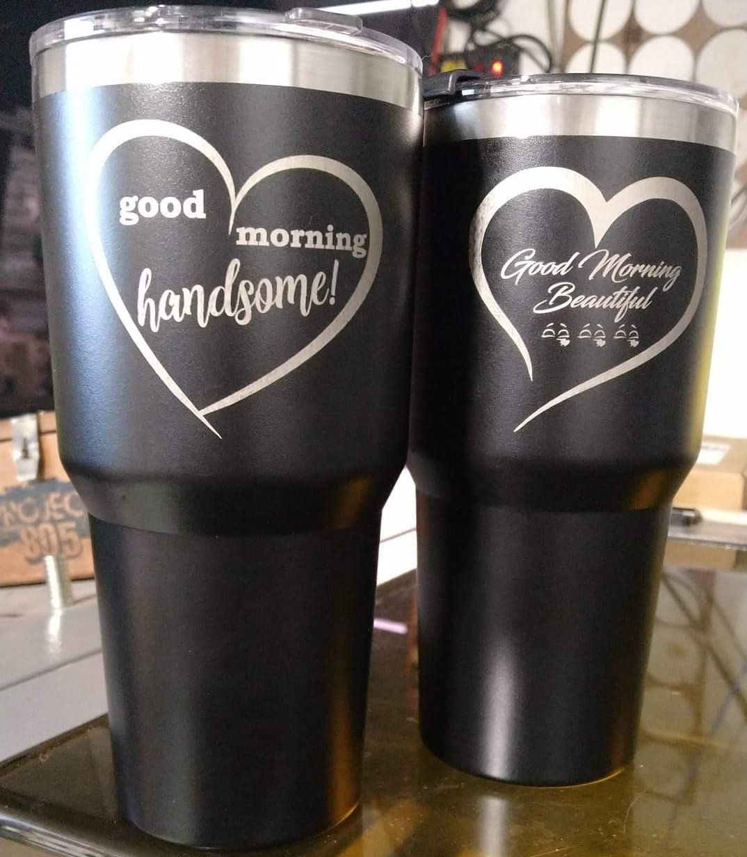 A pair of personalized black engraved tumblers