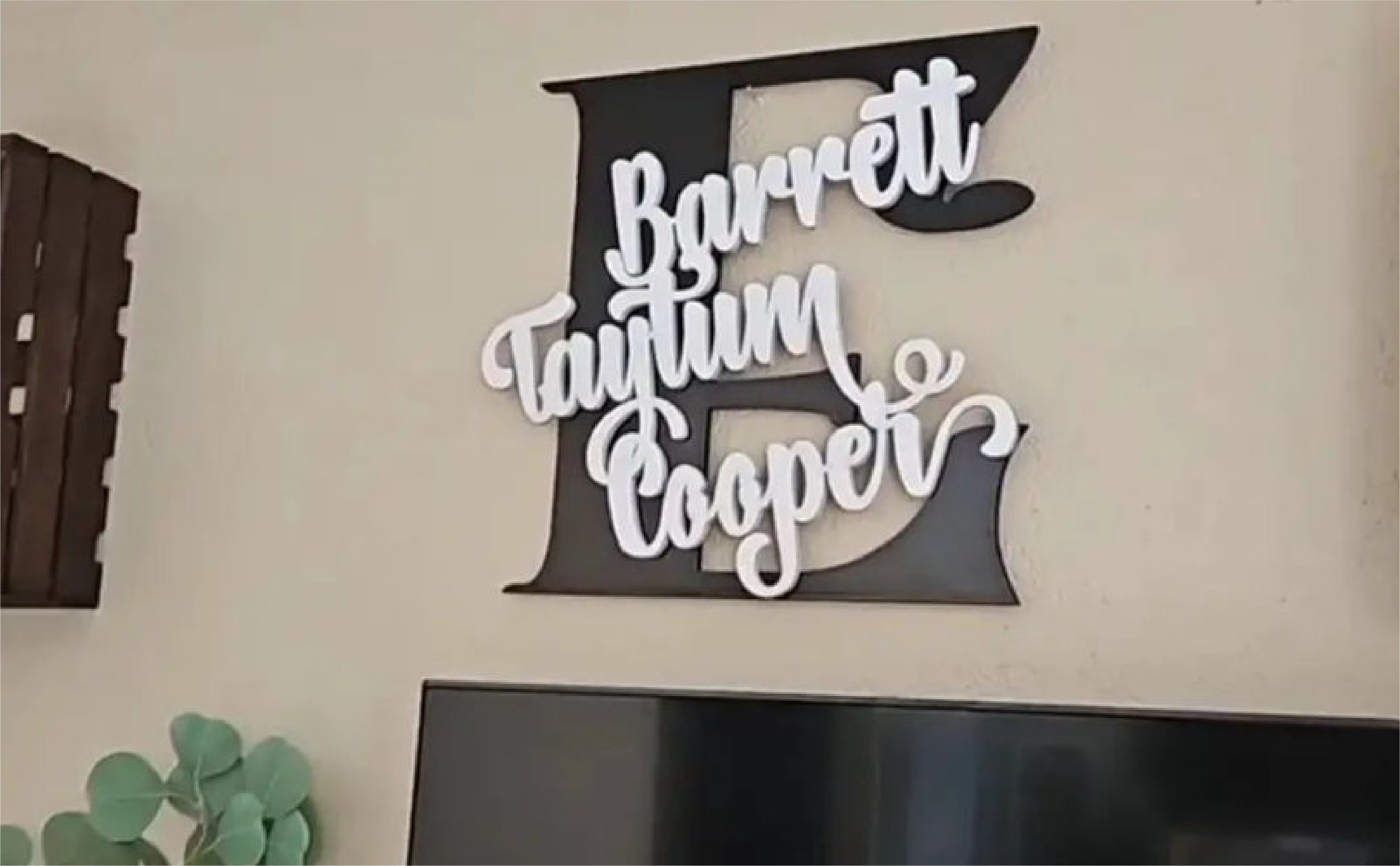 Custom family-name wall art installed in a home